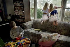 Benjamin Odhner,10, diagnosed with classic autism awaits a diaper change from his father.